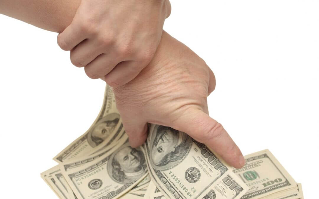Hand holding Hundred dollar bills