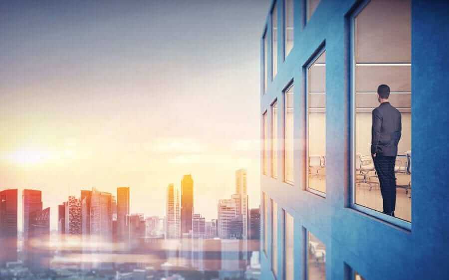 Side of city building during sunset with cityscape in background