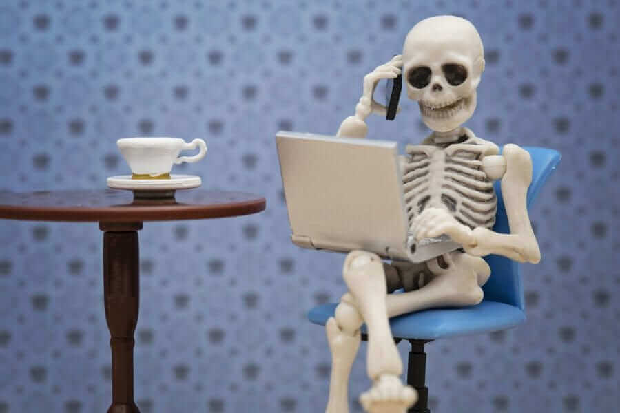 Skeleton on phone and laptop