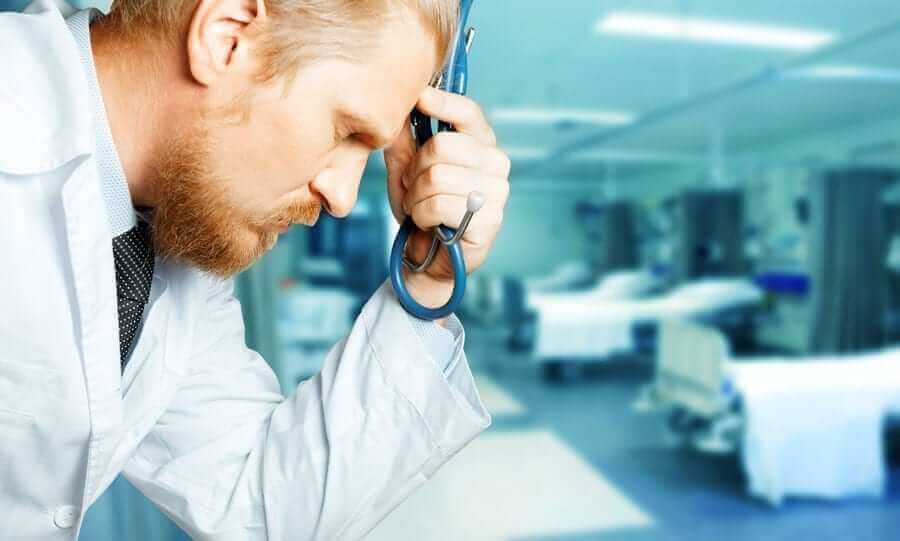 Profile of Doctors face with stressed look and hand on face