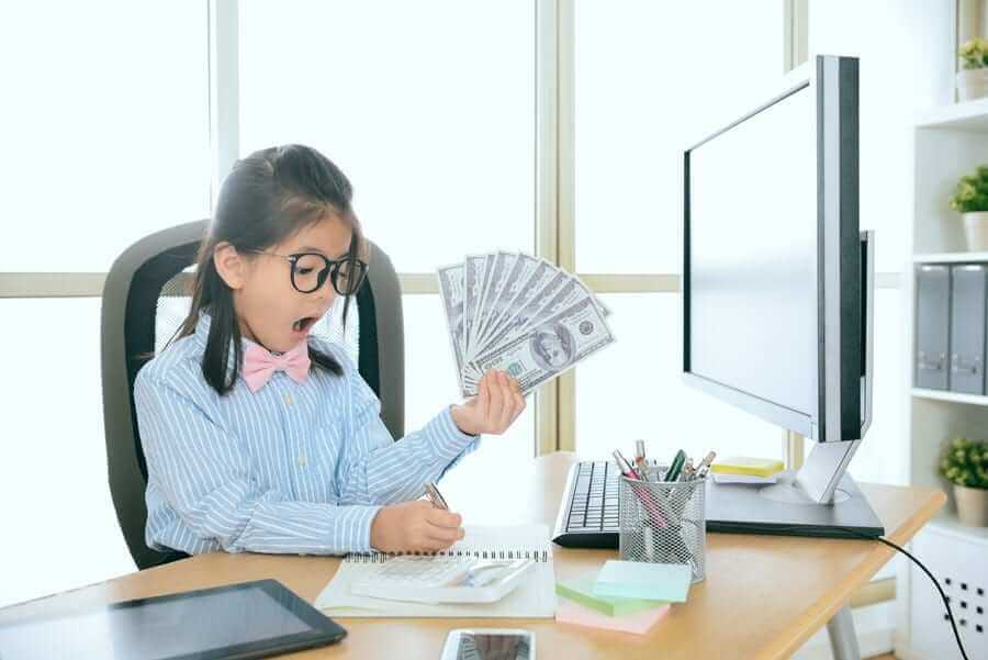 Young girl holding dollars and stressfully writing in notepad
