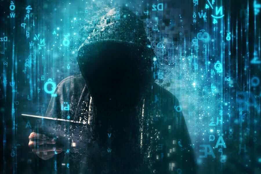 Hacker in hood surrounded by blue code