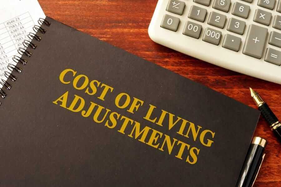 Cost of Living Adjustments book next to calculator