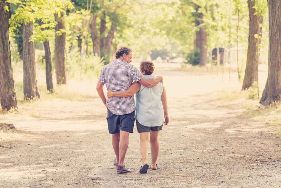 elderly couple walking in park