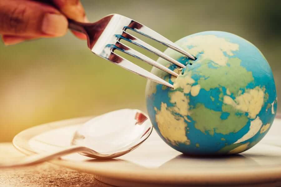fork puncturing small globe on plate