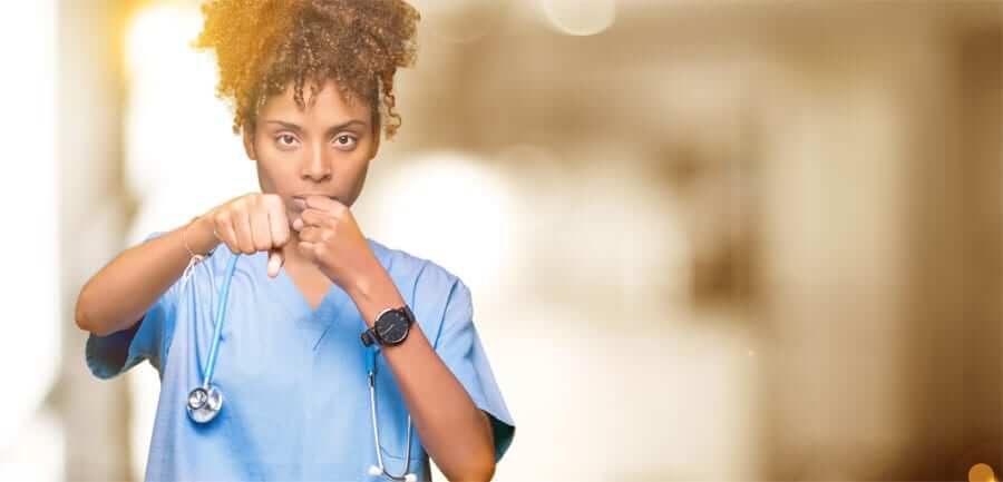 woman in scrubs punching towards foreground