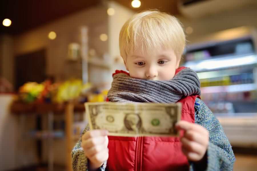 Blonde child holding a dollar bill