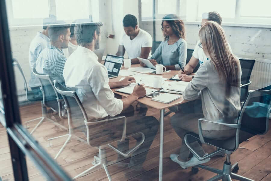 Multiple people sitting at table for meeting