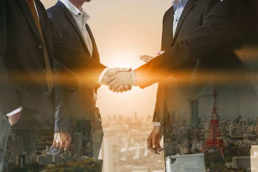 Business People Shaking Hands with city overlay